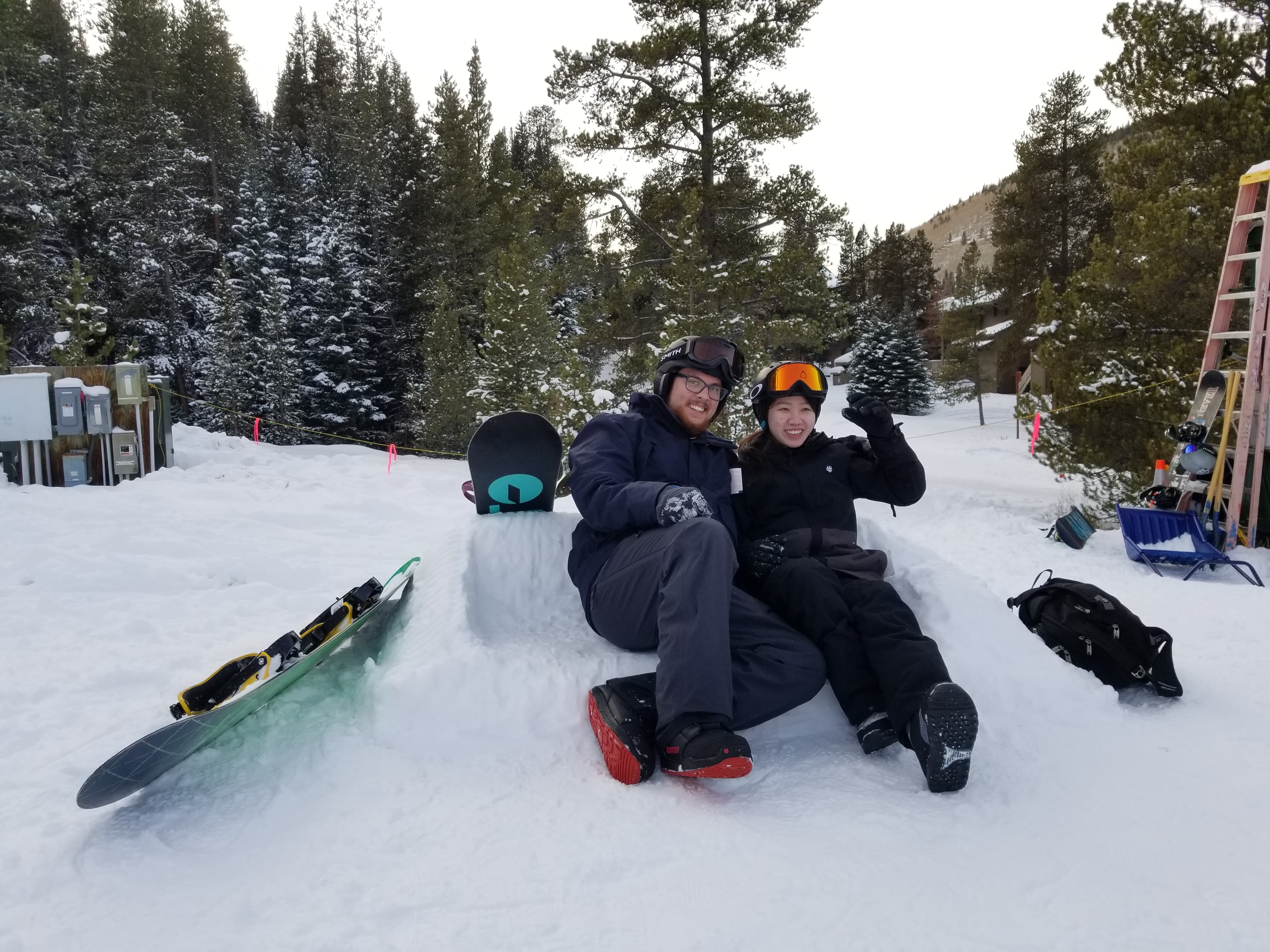 Two people sitting on a snow couch